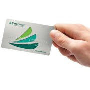 Hand holding care credit card because lice clinics Westchester in New York is now accepting Care Credit.